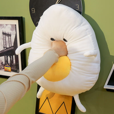 Peluche géante souriante en forme de crane d’œuf