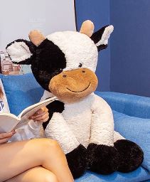 Vache sympathique en peluche géante